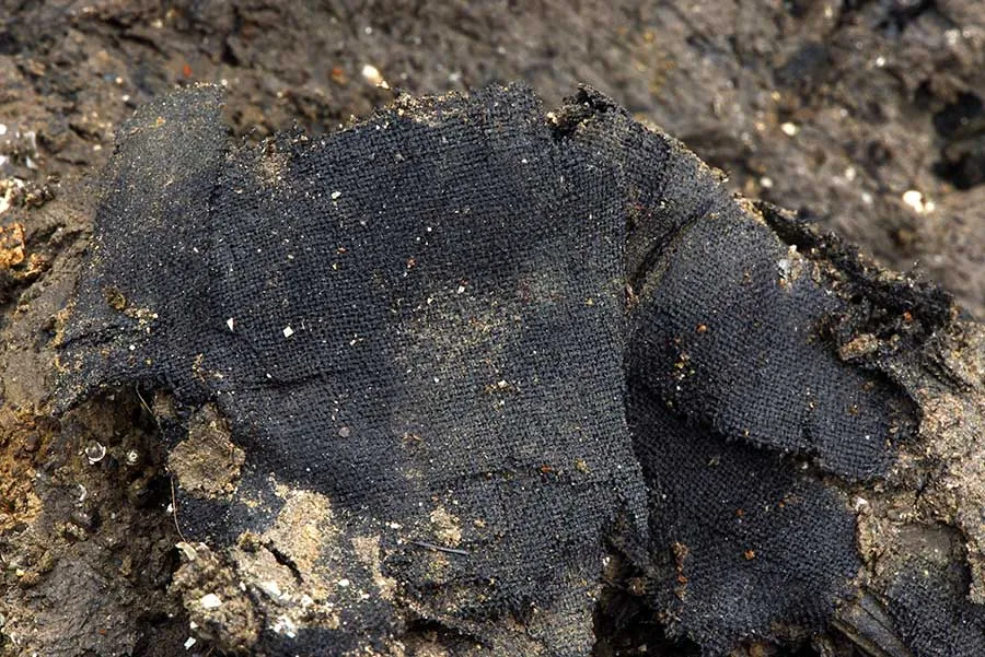 a piece of black fabric in some dirt